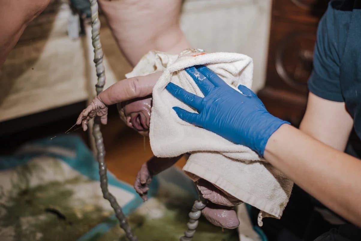 Hands pressed against the wall for stability during labor