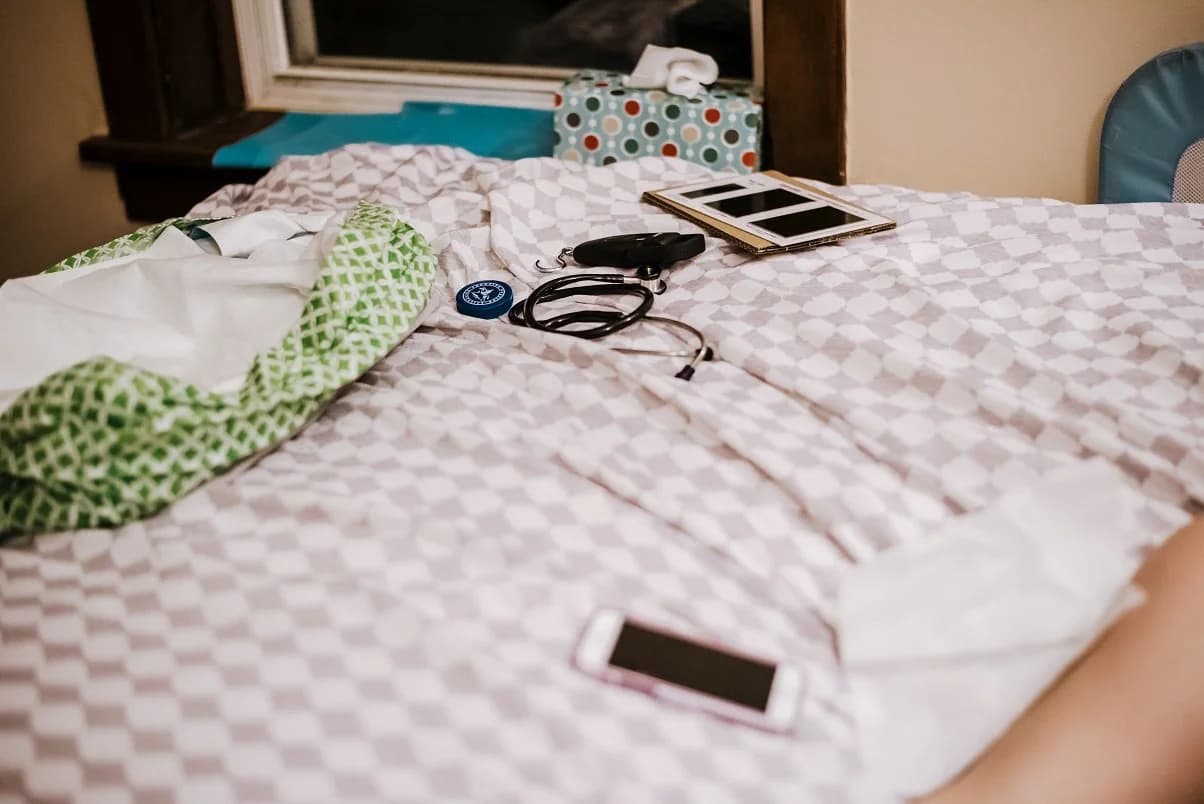 Baby emerging into the warm water of a home birth pool