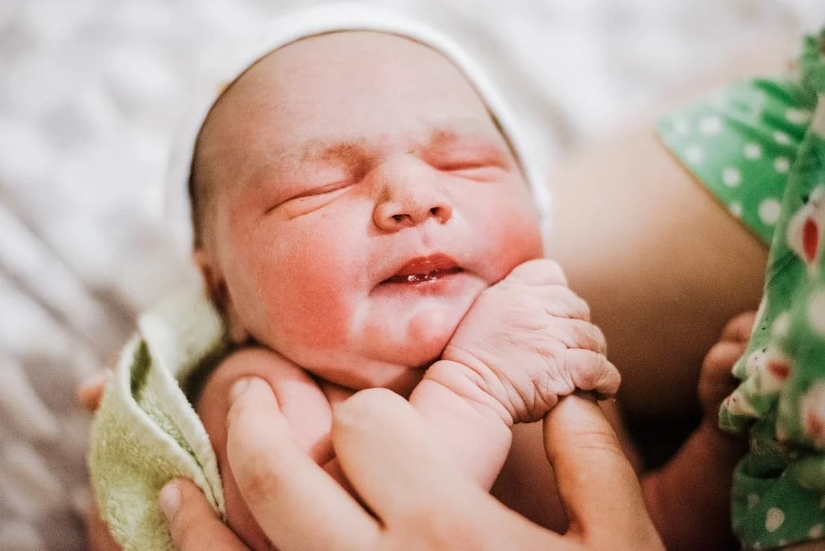 Newborn stretching and discovering the world outside