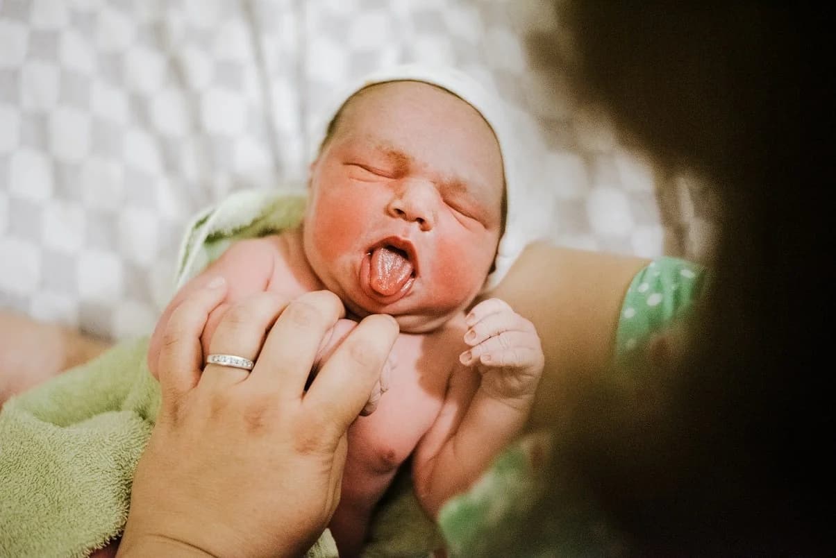 Siblings meeting the newest member of the family
