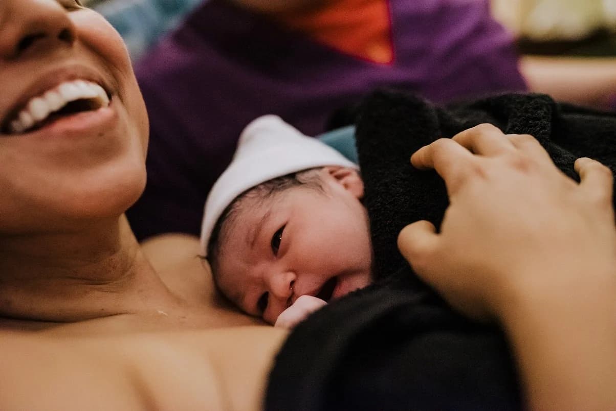 Newborn gazing up with wide, ancient eyes