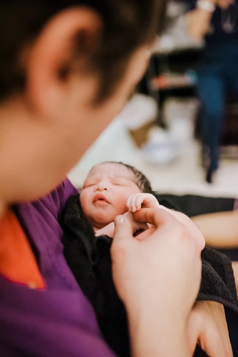 The radiant glow of a mother who has transcended