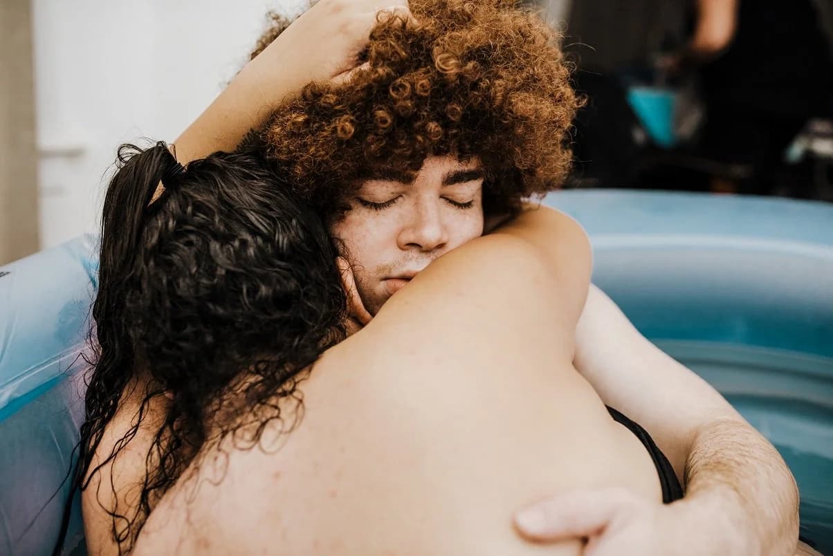 Baby born into the warm water of a home birth pool