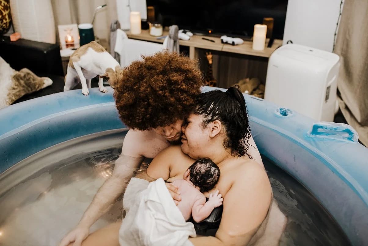 Father holding his newborn with trembling, careful hands