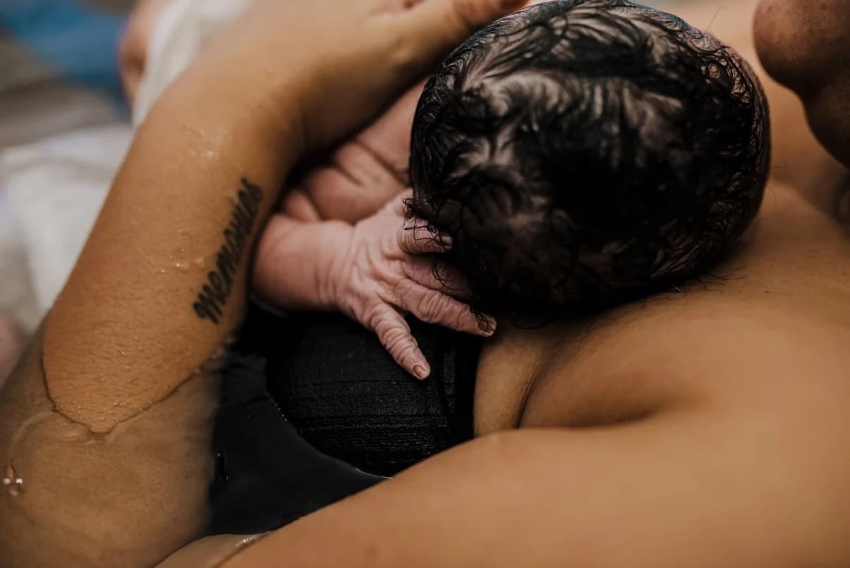 Mother smiling through exhaustion — pure joy